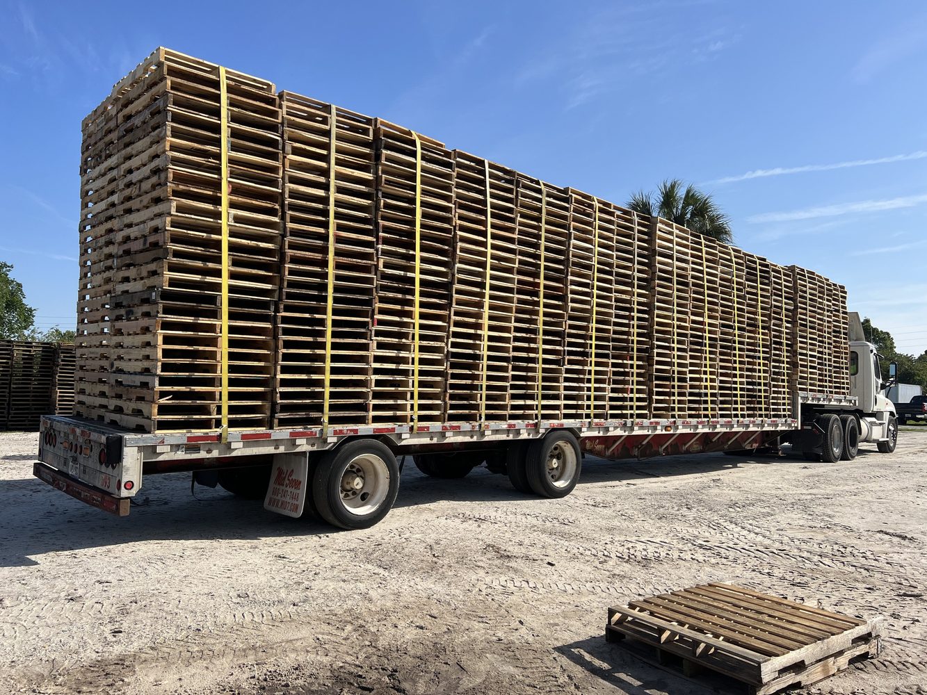 Green Mack truck pallet delivery