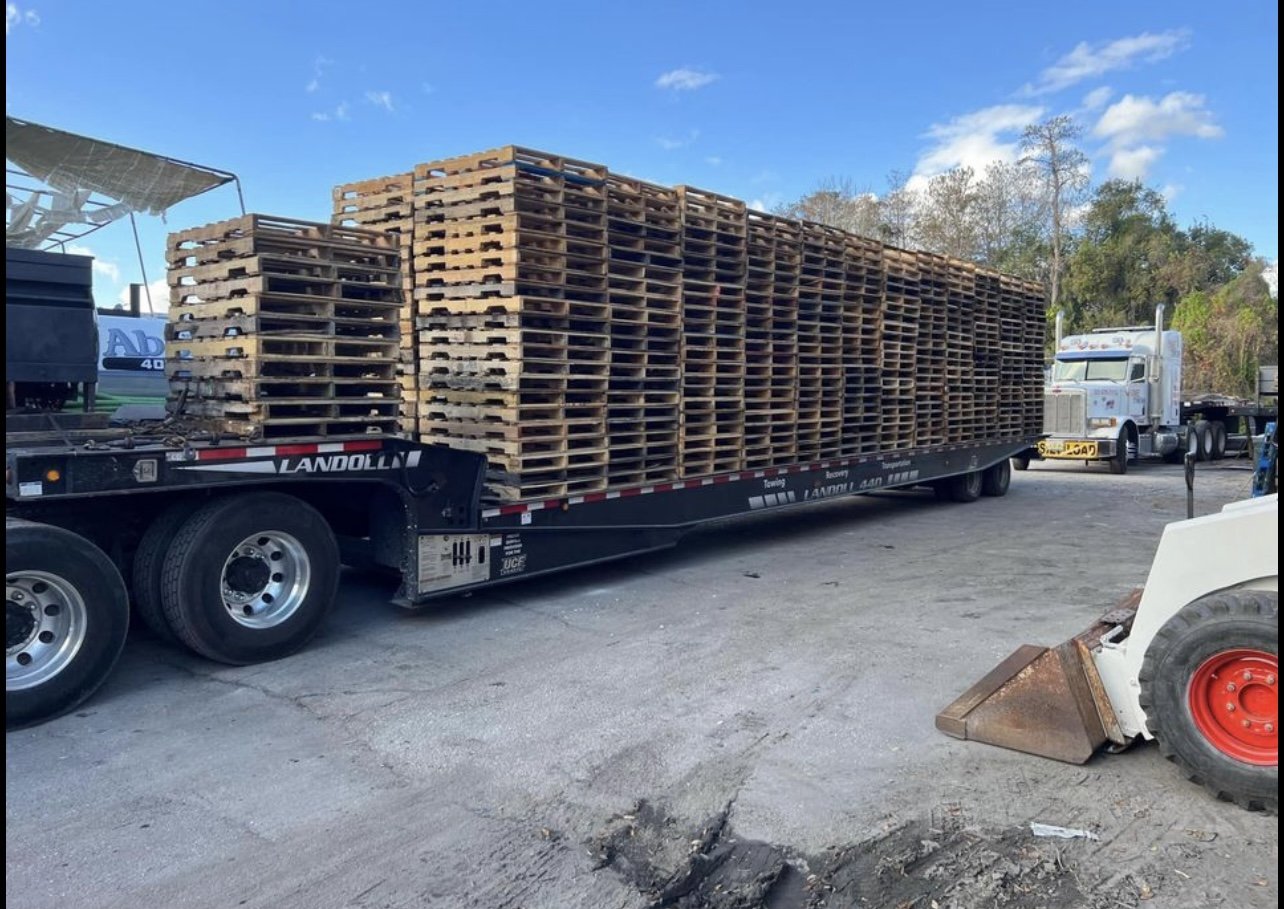 Flatbed Landoll trailer loaded with pallets